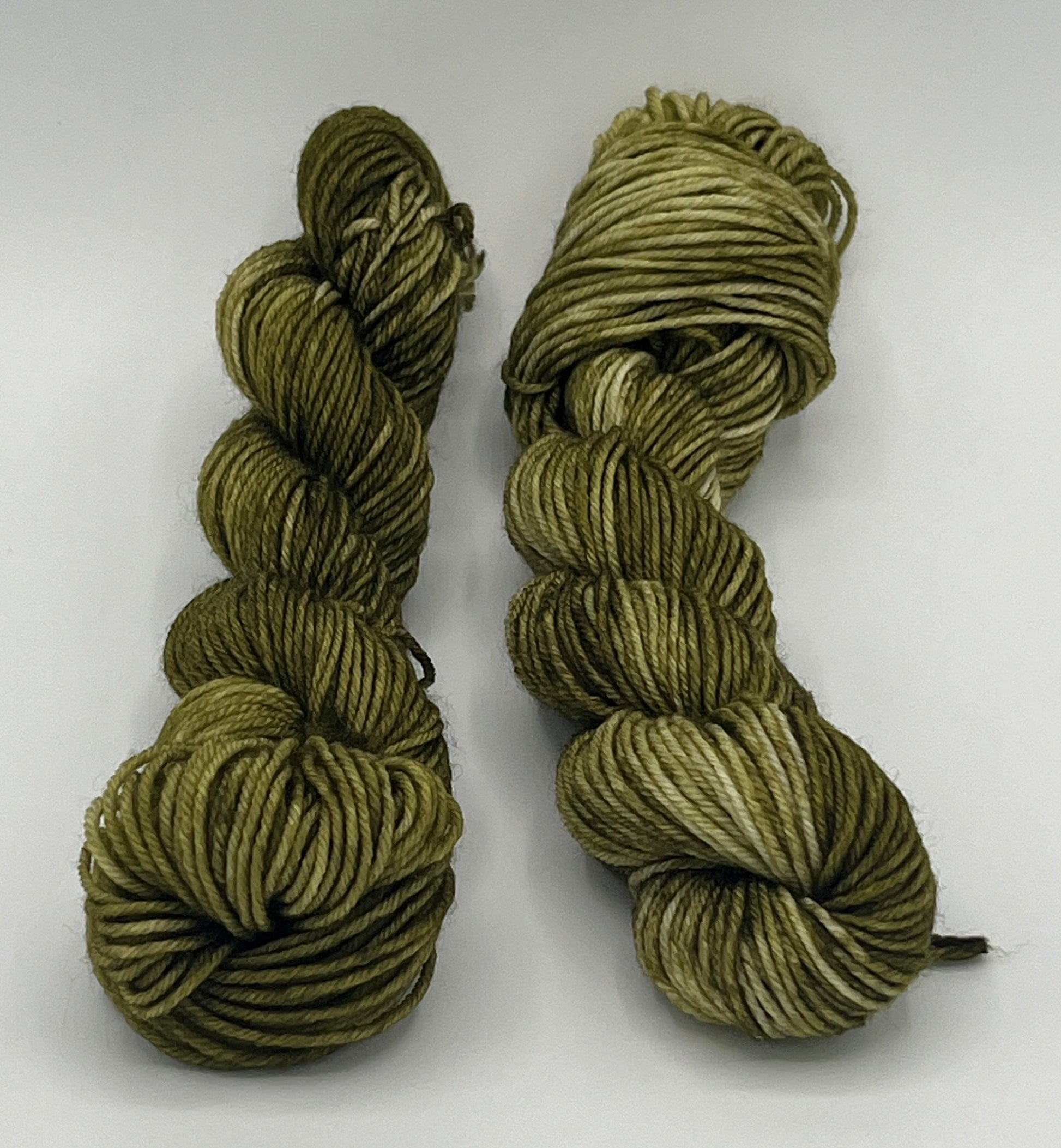 Zwei 20g Stränge Sockengarn Fine Merino in der Farbe Moosmagie, dunkle und mittlere Grüntöne